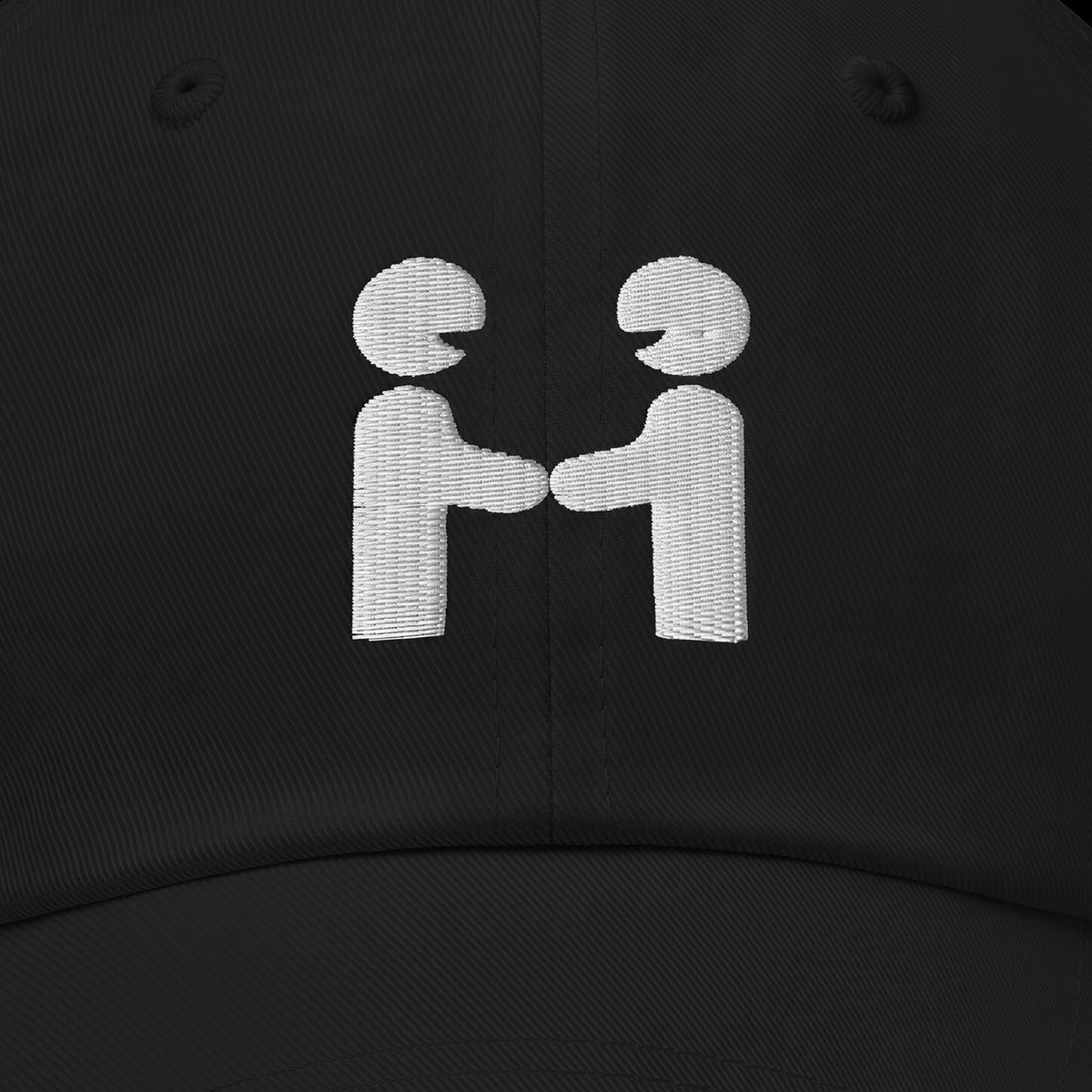 Close-up of the Human-H mark embroidered on the front panel of the cap