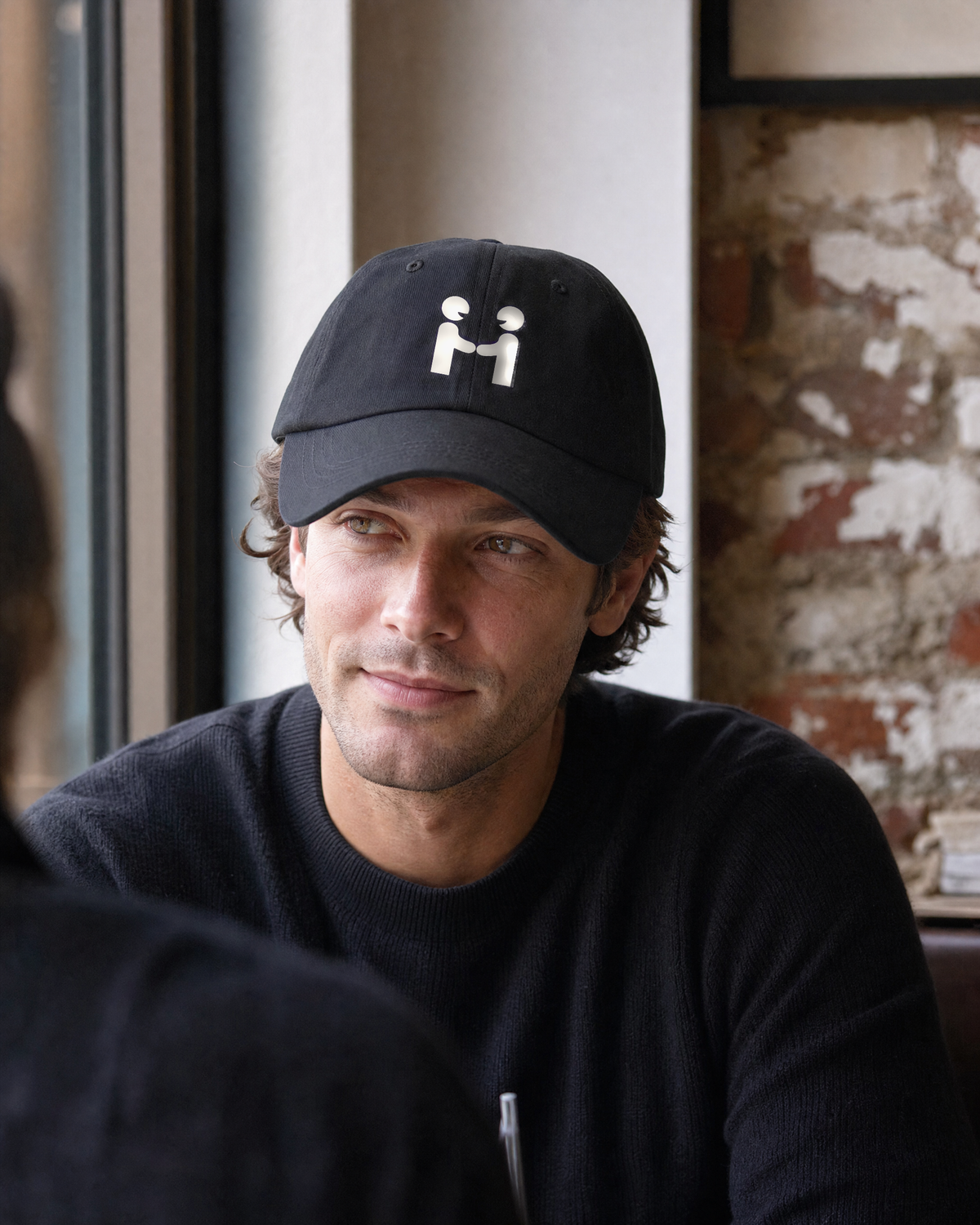 Human-H cap in a relaxed cafe lifestyle portrait