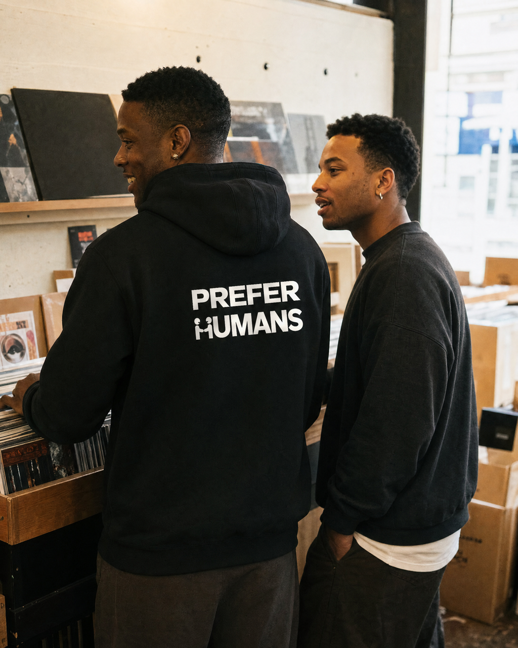 PREFER HUMANS hoodie back print seen while two friends browse records in an independent record shop